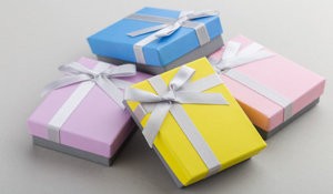 Small Colorful Gift Boxes With Ribbon Bows On Gray Background. P